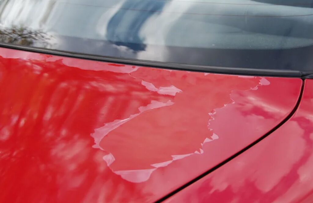 Clear coat worn on red coloured car